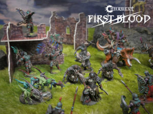 Tabletop battle scene with diverse fantasy miniatures clashing on a grassy battlefield beside ruined stone walls; Conquest First Blood logo in the upper-right corner.