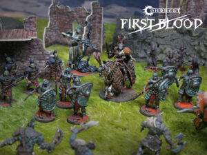 Group of painted fantasy miniatures on a grassy battlefield with ruins in the background and a mounted hero in ornate armor near center-right, logo 'Conquest First Blood' visible in the sky area.5 characters]