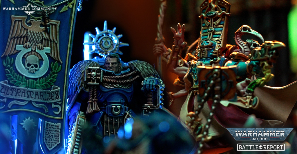 Close-up of ornate Warhammer miniatures with blue banner and glowing blue accents, logo in top-left, battle-ready figures in the foreground.