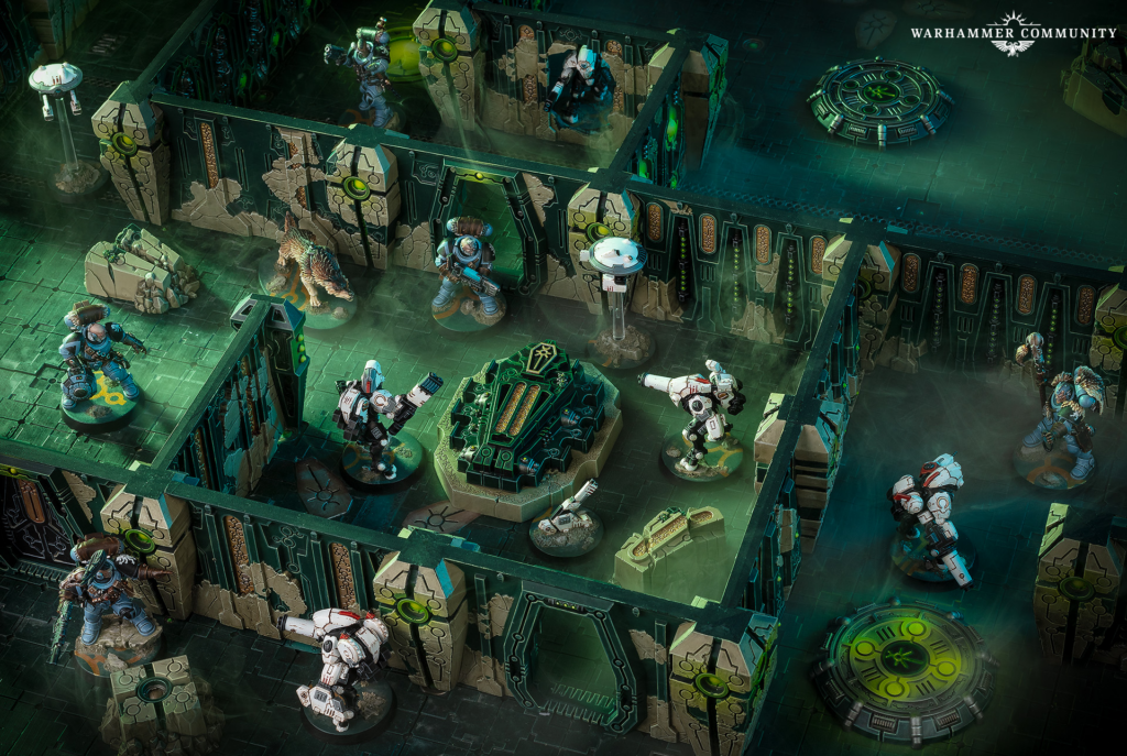 Isometric Warhammer battle scene with space marines and alien creature inside a green-lit ruined fortress