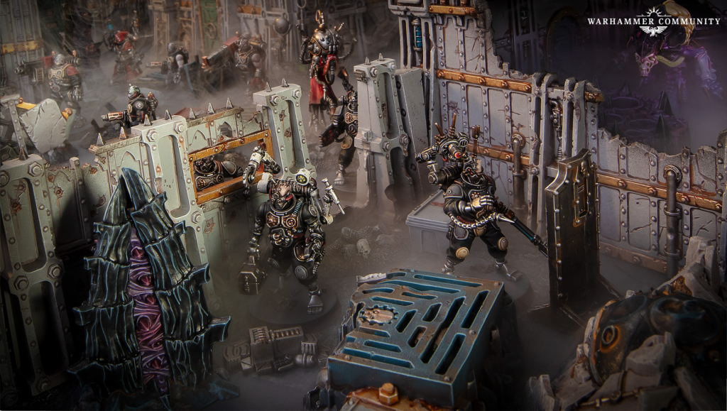 Group of heavily armored Warhammer 40K soldiers clash in a ruined industrial fortress, with smoke and rubble surrounding jagged walls and crates.