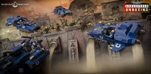 Blue armored tanks race across a ruined wall as green orc troops advance in a Warhammer 40K battle scene.