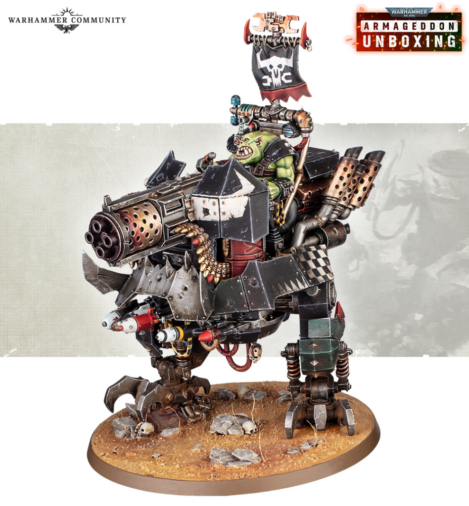 Orc warboss on a heavily armed, junkyard-style walker, on a rocky dirt base in a Warhammer diorama