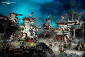 Warhammer miniatures battle scene with towering armored orks and ruined fortifications beneath a blue night sky, logo in top-left corner