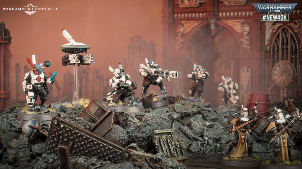 Warhammer miniatures clash on a rubble-strewn battlefield, white-armored troops advancing with gothic ruins in the background.