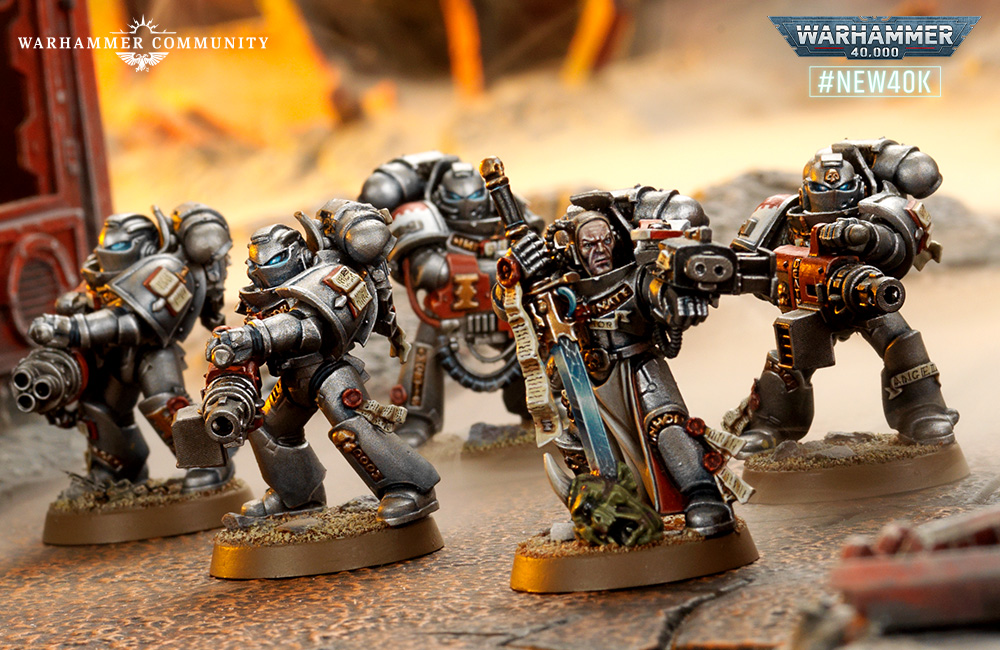 image Frontline Gaming Group of Warhammer 40,000 Space Marines in battle stances with guns and swords on a dusty battlefield; Warhammer Community logo left and #NEW40K logo right.
