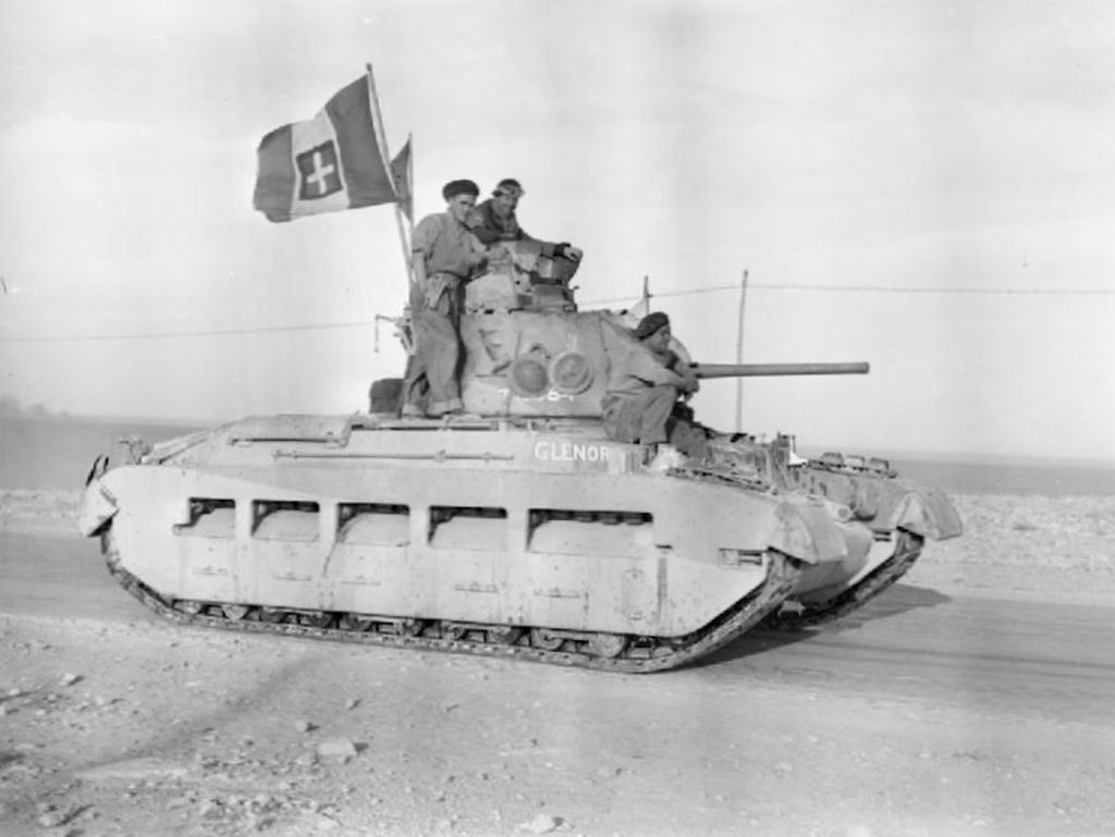 image Frontline Gaming WWII-era tank with three soldiers on the turret and a Swiss flag flying from the antenna.
