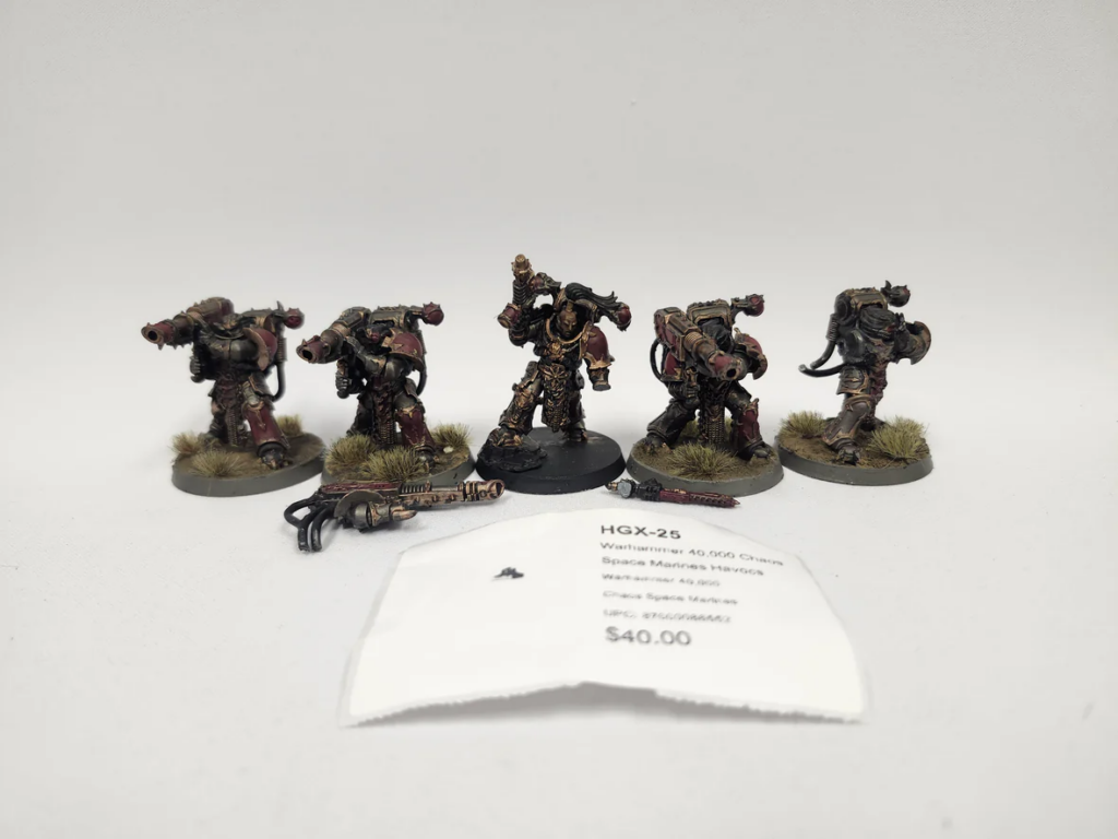 image Frontline Gaming Five painted Space Marines Havocs miniatures on grassy bases, posed with heavy bolters; a price tag rests in front.
