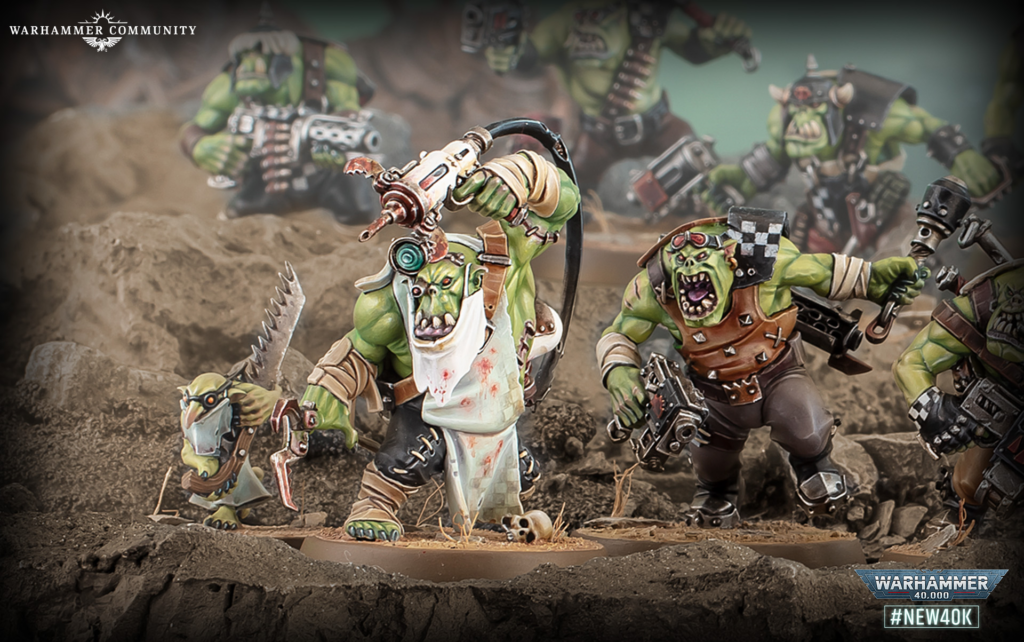 image Frontline Gaming Orc Warhammer 40,000 miniatures in a dirt battlefield, charging with weapons; Warhammer Community branding in the corner.
