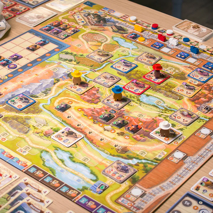 image Frontline Gaming Colorful board game in progress with tiles, cards, and wooden player tokens on a detailed map layout.