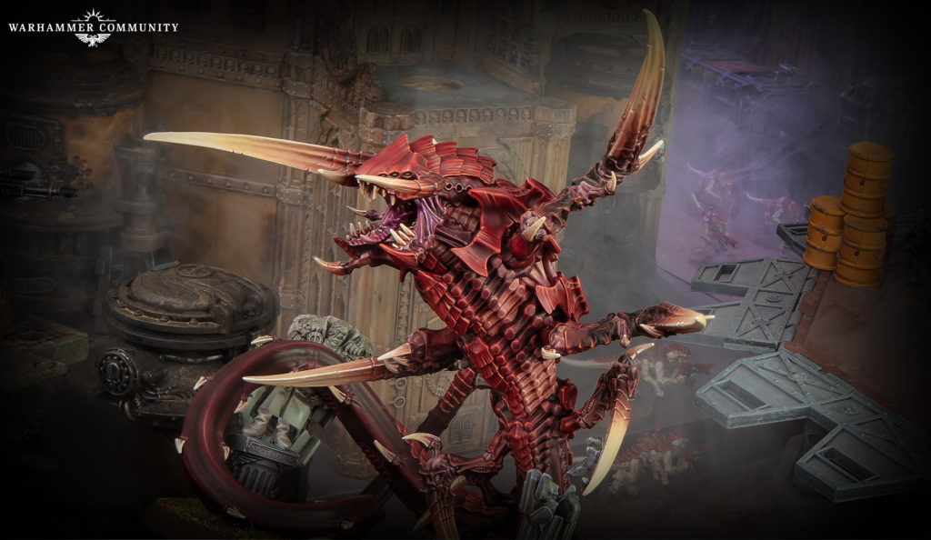 Red, spiked dragon-like Warhammer creature on a metallic battlefield with smoky background and industrial scenery, logo top-left.