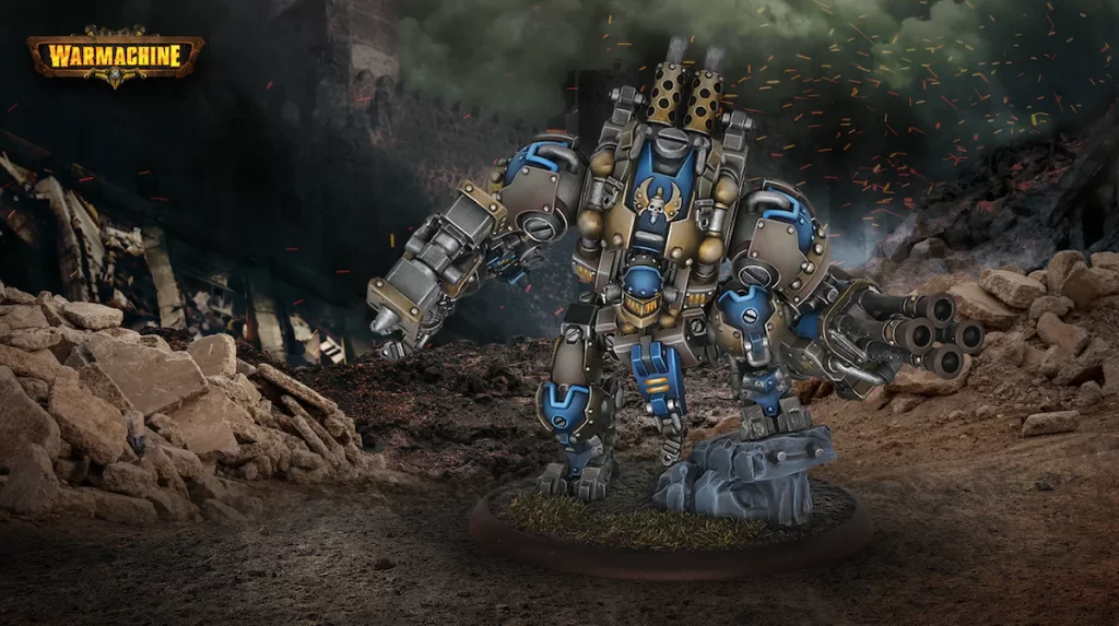 Heavy armored combat walker with blue and bronze plating stands on a rocky battlefield, firing multiple weapons amid smoke and sparks in a ruined area.