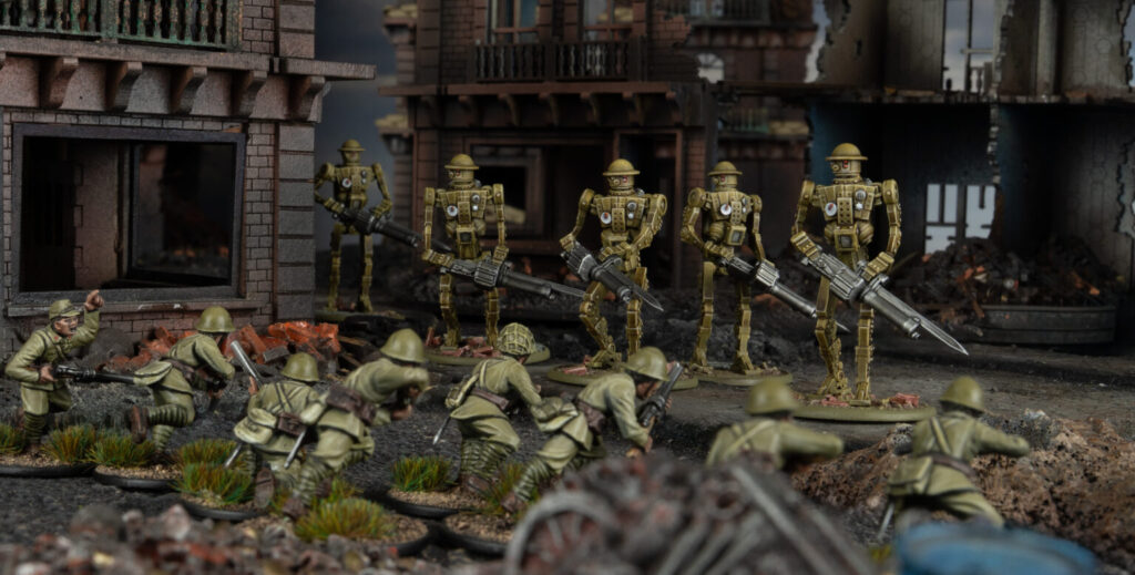 MkIAutomatedInfantry11536x779 Frontline Gaming Miniature battle scene: green-clad infantry advance through rubble toward a line of gold robotic soldiers with rifles amid a ruined cityscape.