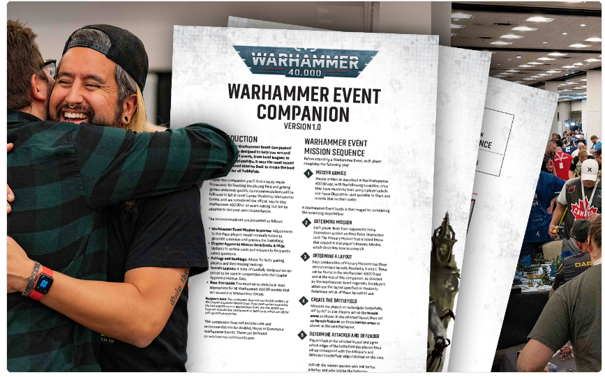 Two people hug in front of a Warhammer Event Companion sheet at a convention near a busy expo floor.