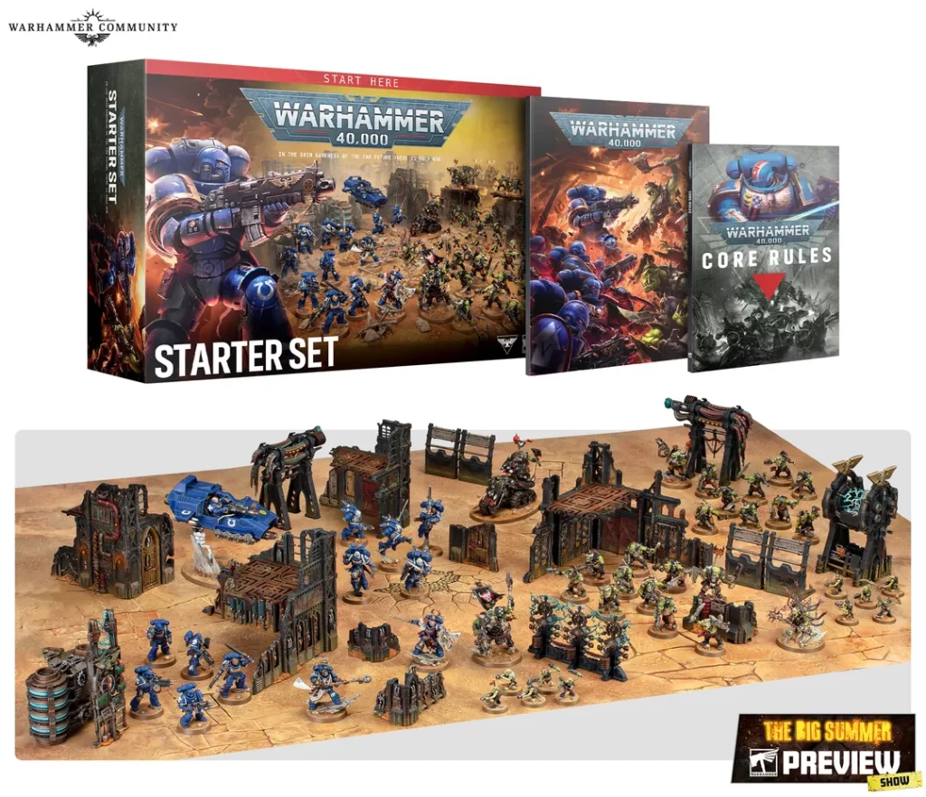 Warhammer 40,000 starter set boxes and a large tabletop battlefield with blue miniatures and ruins for a game session.