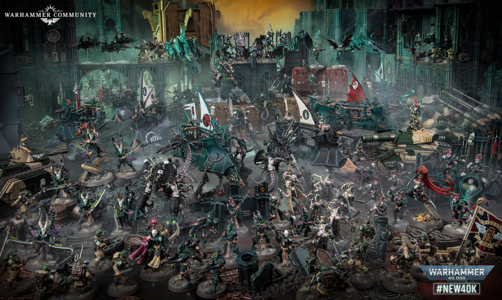 image Frontline Gaming Extensive Warhammer 40,000 battle scene with dozens of miniatures, green-armored units, tanks, and flying troops in a Gothic, ruined cityscape.