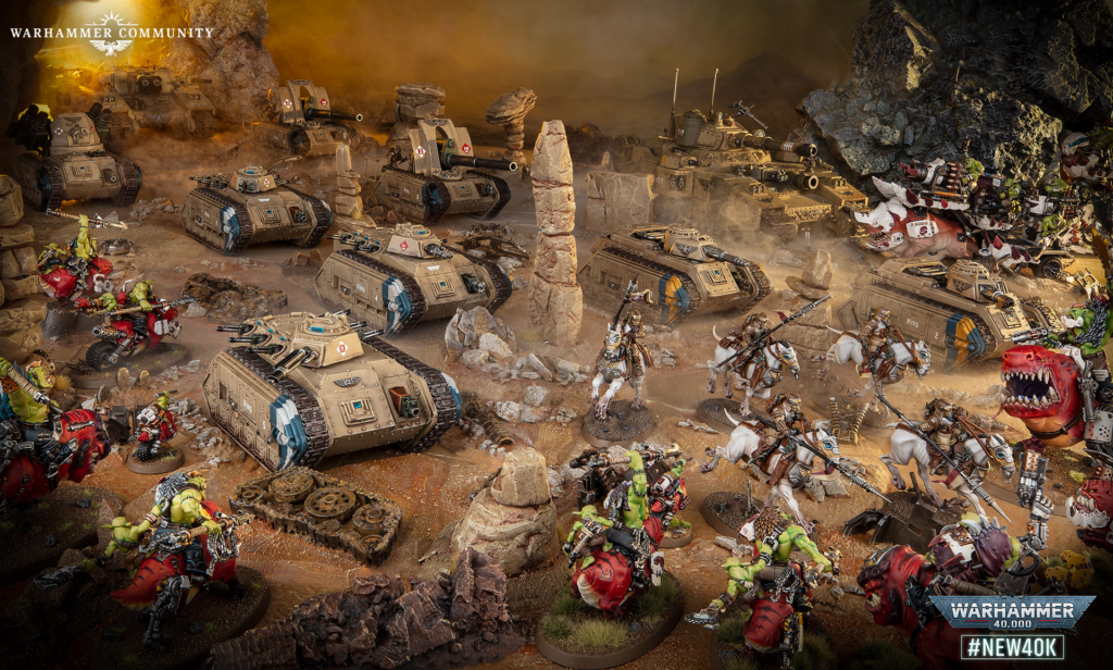 Warhammer 40,000 battle scene with many armored tanks clashing against green orc forces in a rocky desert terrain.