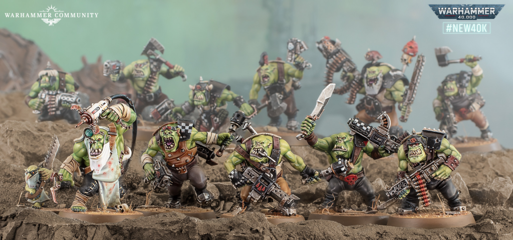 image Frontline Gaming Group of green-orc Warhammer miniatures clash on a rocky battlefield; Warhammer Community logo and #NEW40K visible.