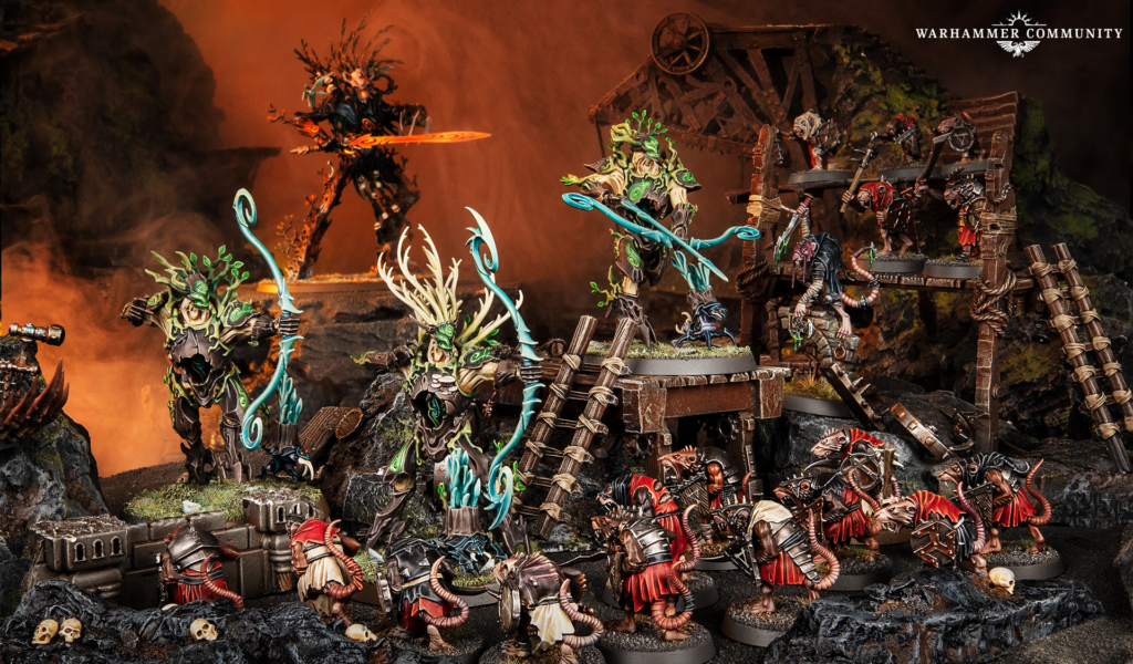 Warhammer Community battle diorama: richly painted miniatures clash on a ruined wooden bridge over lava and skulls