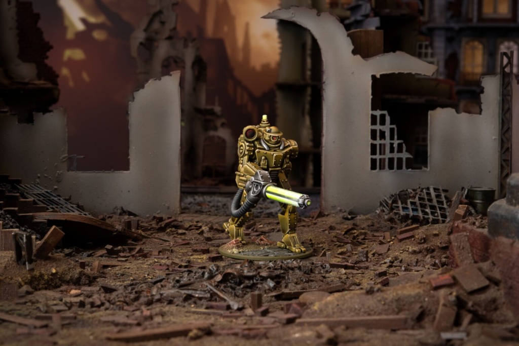 Gold-colored armored robot figure holding a glowing lime-green laser gun stands amid rubble in a ruined city scene.