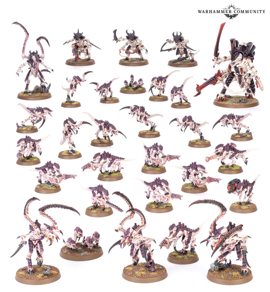 Group of Warhammer Tyranid miniatures in purple and pink hues on round bases, arranged as a display or collection.
