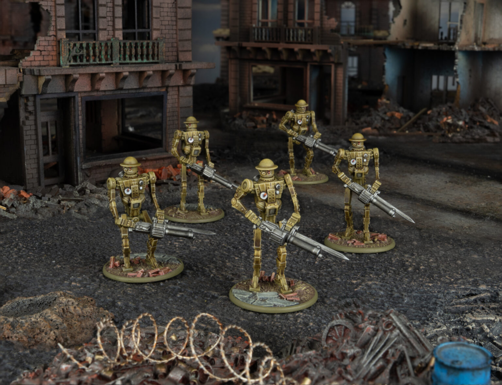 image Frontline Gaming Five gold-colored robotic soldiers with rifles in a ruined urban street backdrop with rubble and barbed wire foreground.