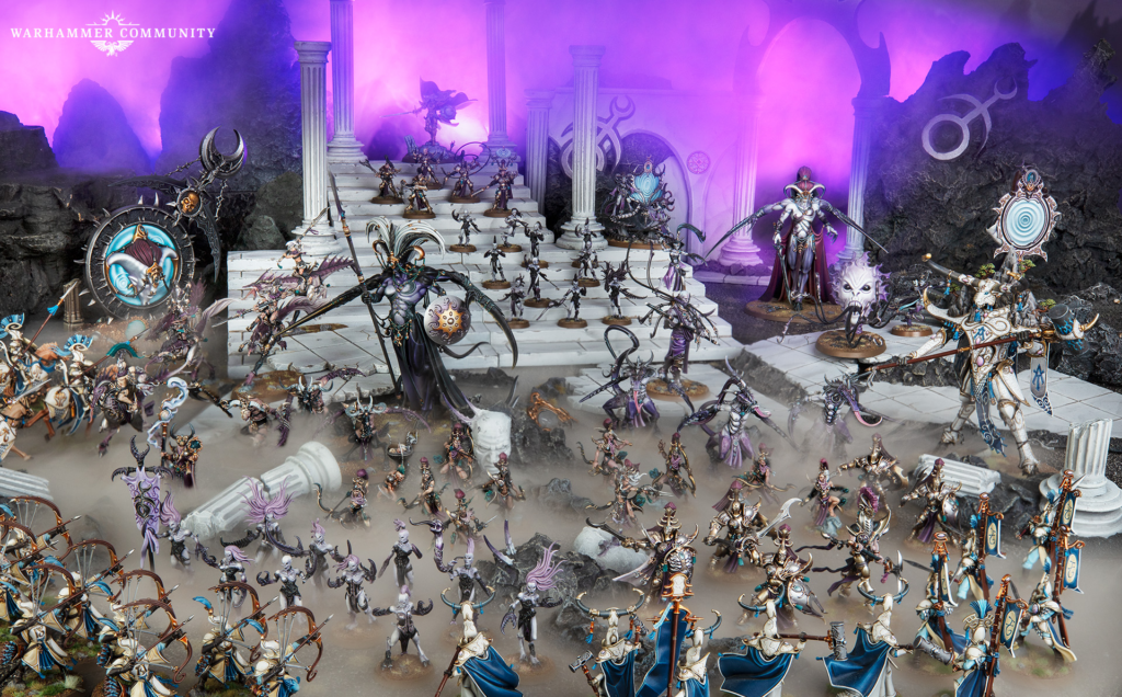 Massive Warhammer battle scene with dozens of elaborately painted miniatures clashing on a ruined white staircase and purple foggy backdrop