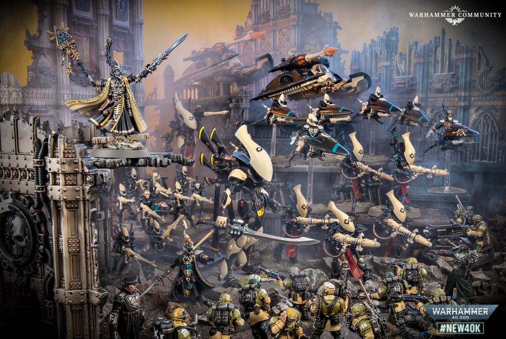 Warhammer 40k diorama: ornate sorcerer leads infantry and jetbikes across a ruined fortress battlefield, with Smoke and Citadel scenery in the background.