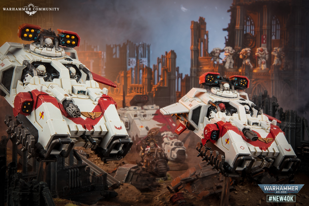 Two white and red Warhammer 40k tanks roll through a destroyed cityscape, with logos in the top-left and bottom-right.