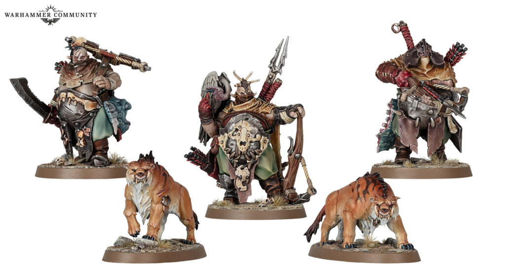 Three painted Warhammer miniatures: orc fighters with weapons on round bases, flanked by two snarling wolves on rocky bases.