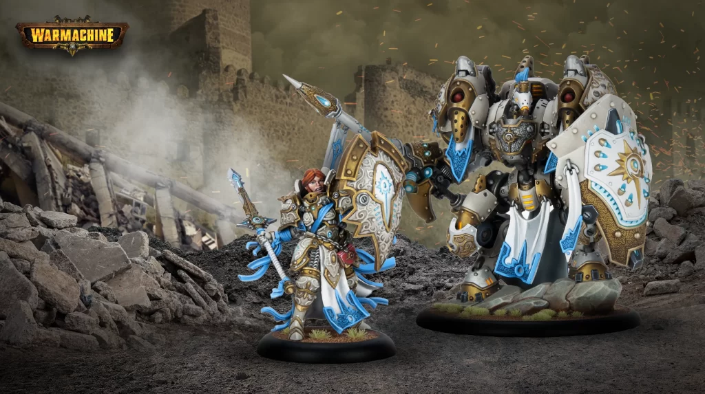 Header2500x1400ConstanceBlaizeGallant Frontline Gaming Two ornate WarMachine miniatures in blue and gold armor clash on a rubble-filled battlefield with a ruined wall in the background.