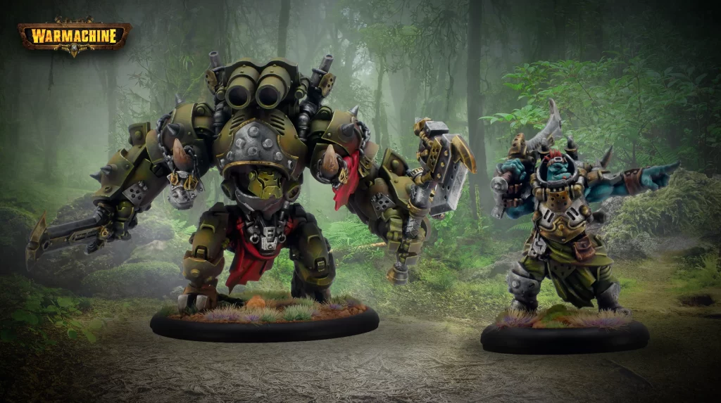 Two heavily armored ork miniatures from Warhammer 40K stand ready for battle in a misty forest, each on a round base with grassy tufts.
