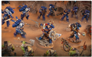 Tabletop battle scene with blue armored Space Marines clashing central figure wields a sword and shield leading the assault
