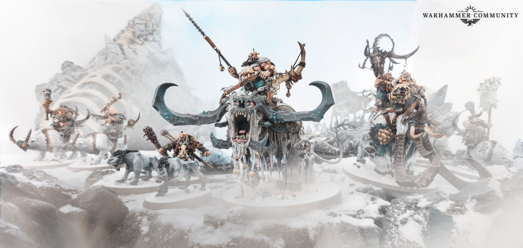 Warhammer miniatures in a snowy icy battlefield, led by a massive horned demon with skulls and jagged weapons; Warhammer Community logo in corner.