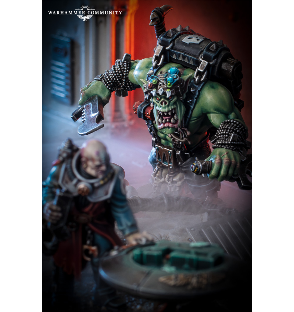 image Frontline Gaming Warhammer Community miniature scene showing a green skinned orc with a massive axe charging at a human warrior in detailed armor smoky battlefield and a circular base in the foreground