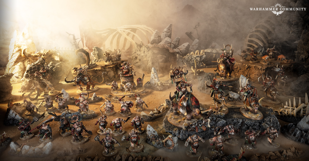 image Frontline Gaming Warhammer battle scene with dozens of painted miniatures fighting among ruined rocks and dust