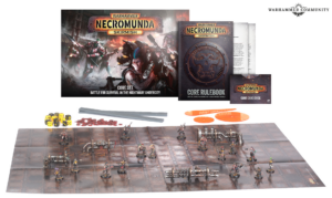 Necromunda Skirmish core set and rulebook with miniatures dice rulers and game board on a tabletop
