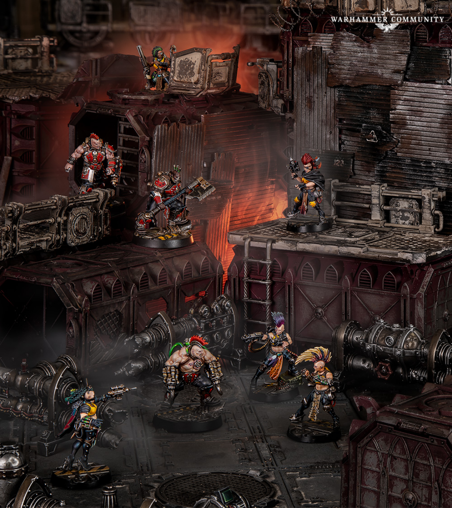 Warhammer miniatures clash on a rusted industrial battlefield with red lighting and smoky atmosphere several characters poised for combat