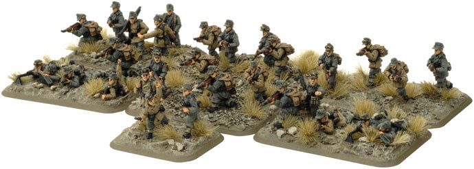image Frontline Gaming Collection of painted WWII infantry miniatures advancing across rocky, scrubby terrain on individual bases (tabletop diorama).