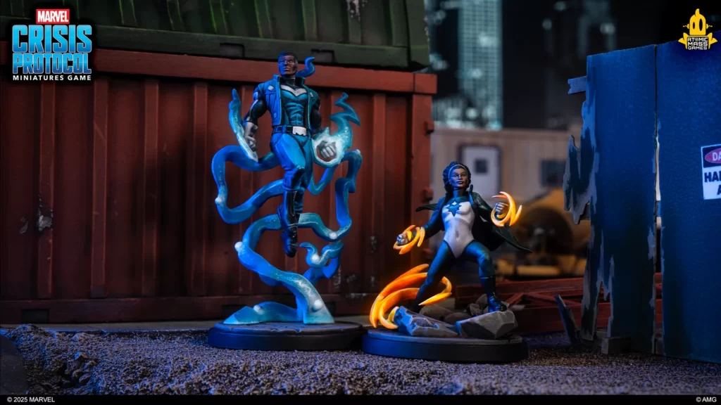 Two Crisis Protocol miniatures on a gritty diorama: a blue-energy male hero with twisting energy and a female sorcerer casting orange flames.