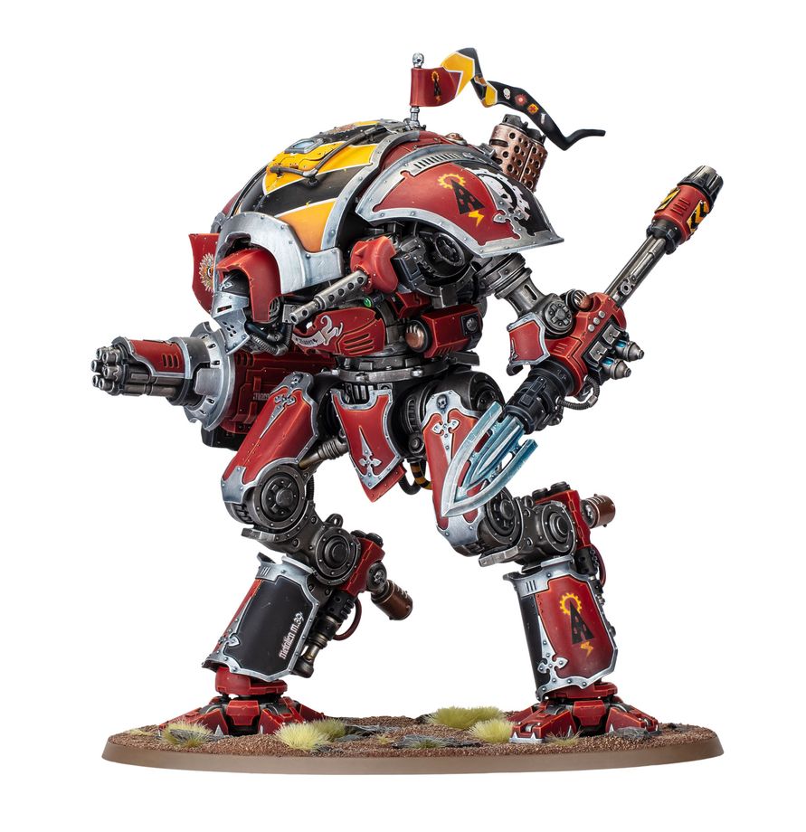 Red and yellow armored battle mech miniature posed with a double bladed axe standing on a textured grassy base