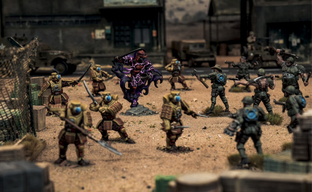 Group of armored soldiers in a desert diorama surround a purple demon centerpiece mid battle
