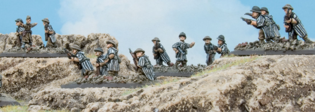 Screenshot 20260806 152850 Frontline Gaming Miniature WWI soldiers in a rocky trench aiming rifles and taking cover beneath a blue sky