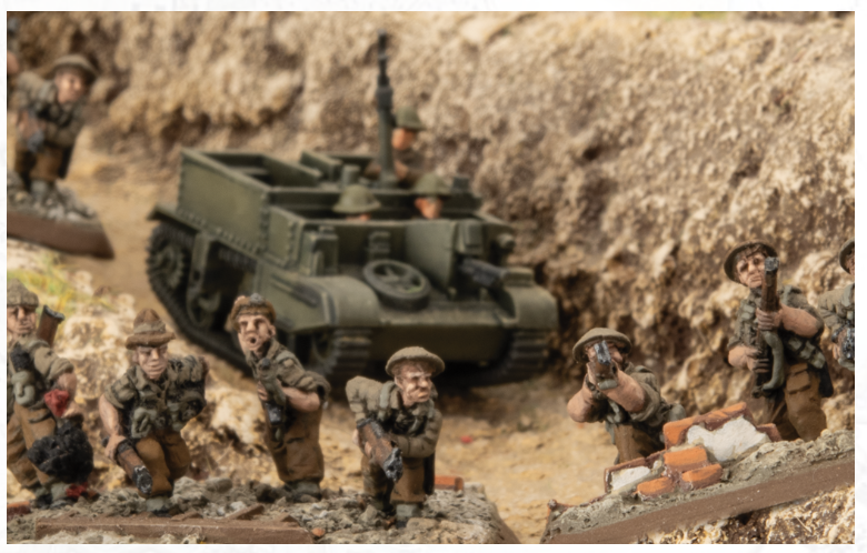 Toy military diorama with several camouflaged soldiers and a green armored vehicle in a dusty trench scene