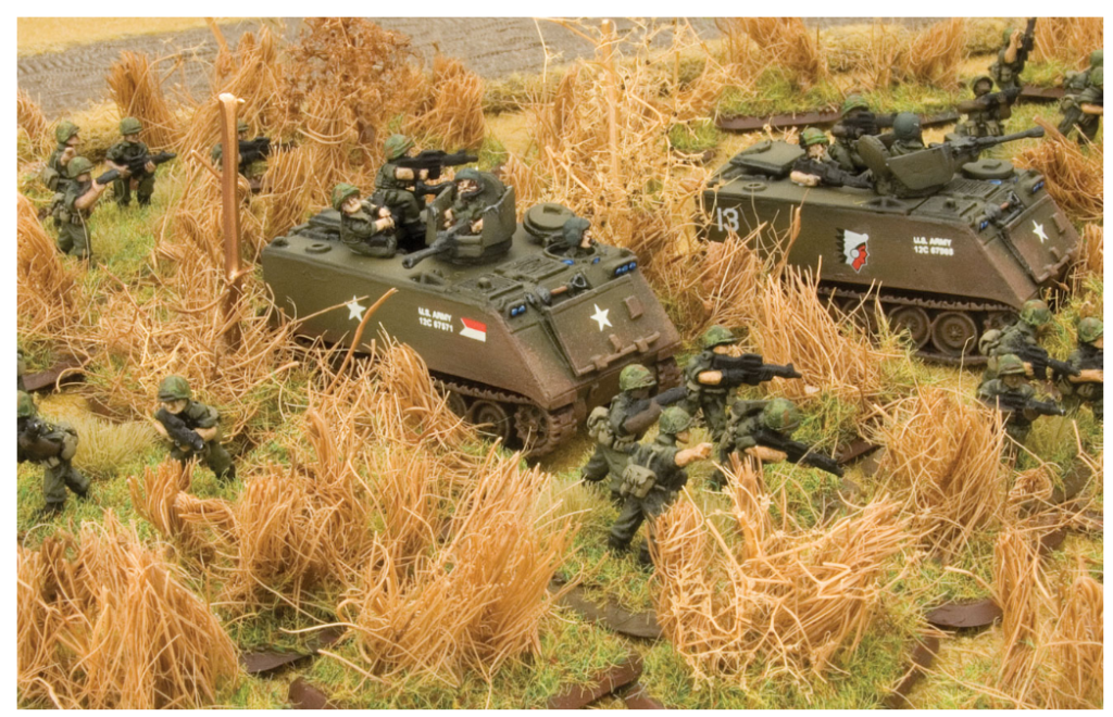 Screenshot 20260813 084302 Frontline Gaming Scale toy army scene with armored vehicles and soldiers advancing through tall dry grass
