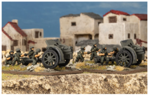 Plastic toy soldiers push a large cannon across a rubble strewn battlefield with ruined buildings in the background