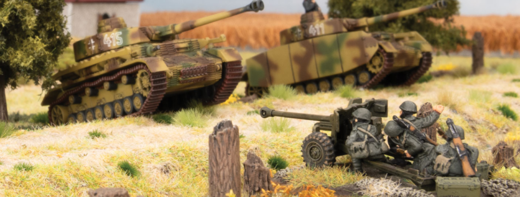 Screenshot 20260827 084728 Frontline Gaming Miniature World War II diorama two camouflaged tanks in the background and three soldiers manning a field gun in a grassy rural setting