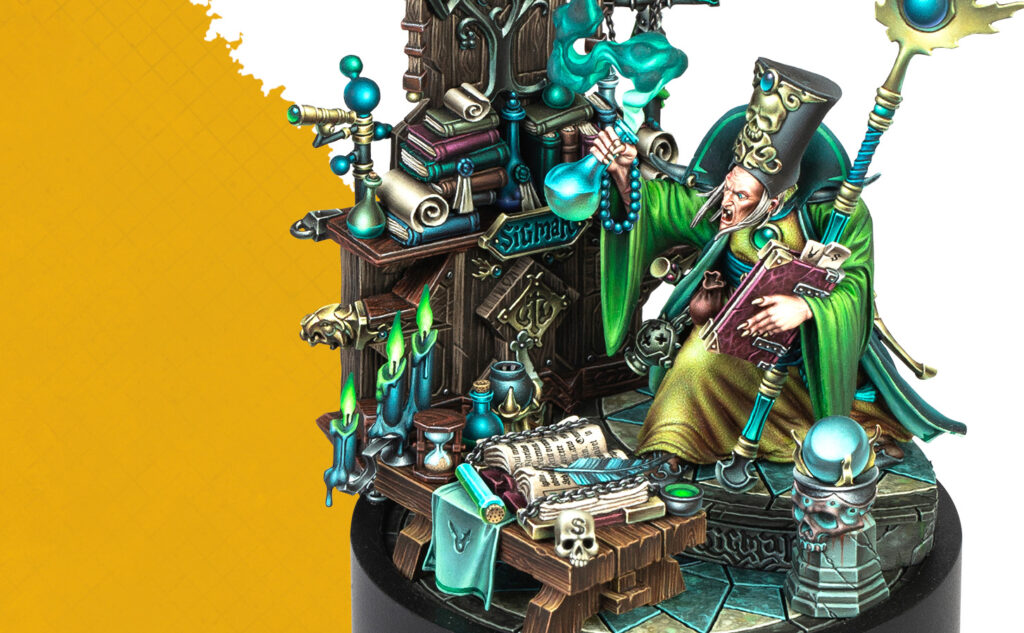 eventspaintingclassesaug201featurecbared2dpw Frontline Gaming Fantasy wizard in green robes sits at a cluttered desk filled with books candles and mystical artifacts