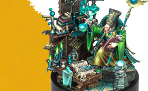 Fantasy wizard in green robes sits at a cluttered desk filled with books candles and mystical artifacts