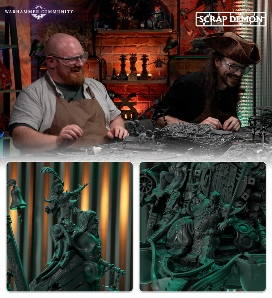 Two men wearing safety glasses and aprons assemble Warhammer miniatures at a workshop with model kits on the table and a brick wall backdrop Warhammer Community and Scrap Demon logos